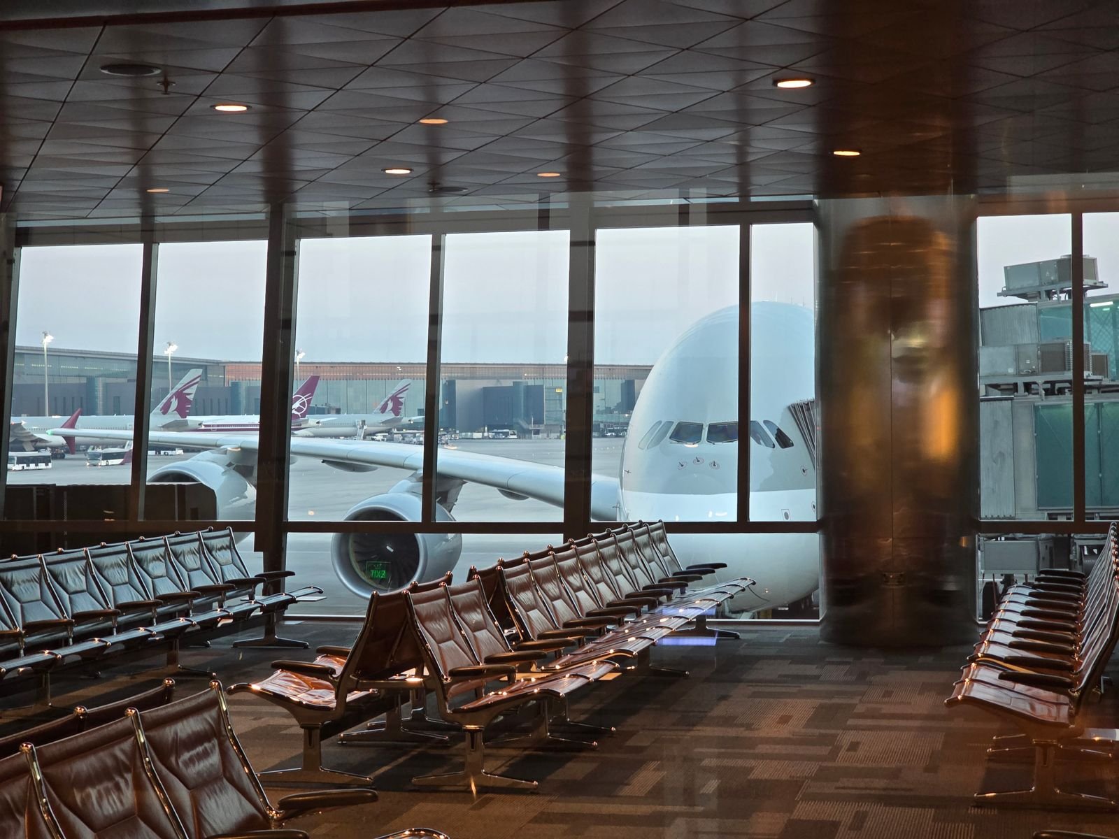 Airport waiting area with seating and natural light.