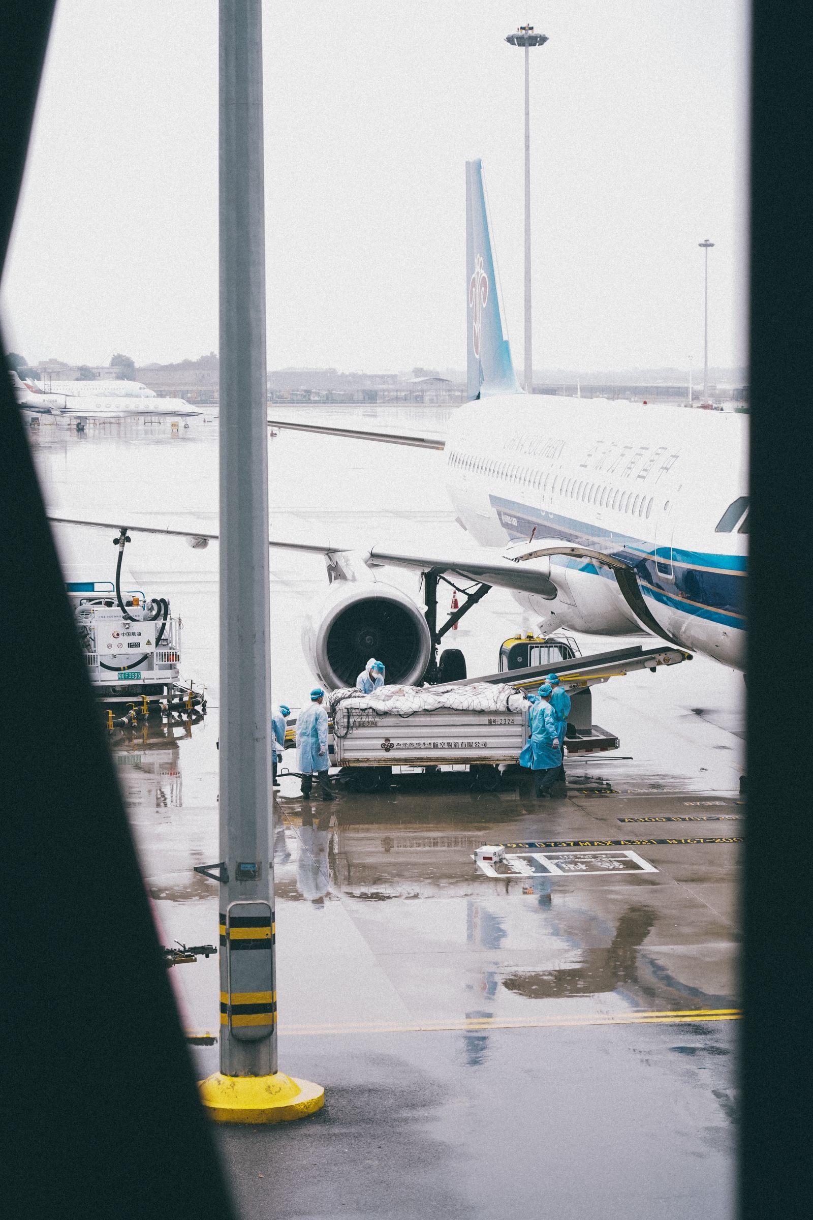 An aircraft at a gate seen from the terminal.